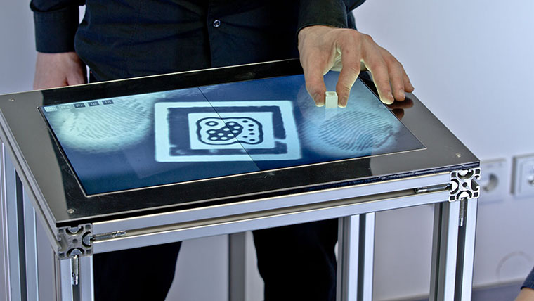 Fiberio also detects hovering objects, such as hands, as well as tangible objects by recognizing fiducial markers